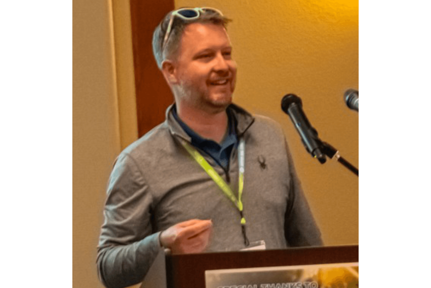 A man at a podium smiling
