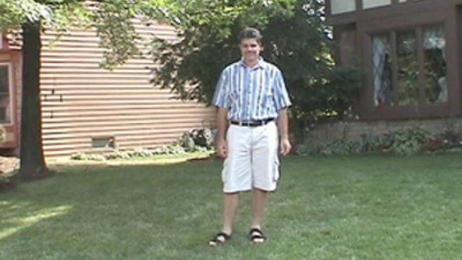 A lawn with a house in the background.